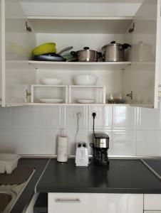 a kitchen with white cabinets and a counter top at Casa SolyMar Canarias 6 in Caleta De Fuste