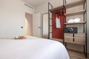 Katil atau katil-katil dalam bilik di Arrivo Apartments