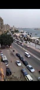 una concurrida calle de la ciudad con coches aparcados en un estacionamiento en شقه سكنيه, en El Cairo