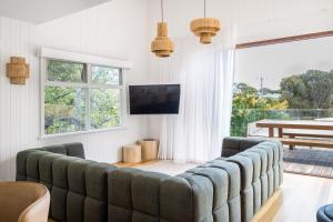 a living room with a couch and a tv at Peninsula Luxury Beach House FREE WI-FI in Rosebud