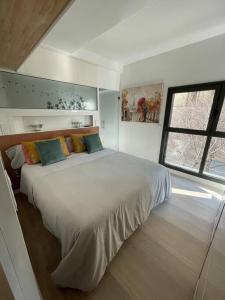 a bedroom with a large white bed with a window at At-II Hub Luxury New Apartments in Barcelona