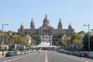 a large building with a fountain in the middle of a street at At-II Hub Luxury New Apartments in Barcelona