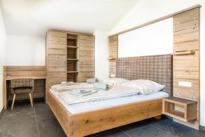 a bedroom with a large bed and a desk at Taurachhof Astlehen in Plankenau