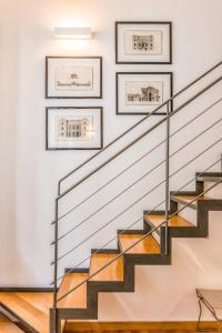 a staircase in a house with three pictures on the wall at Loft Crocetta in Turin