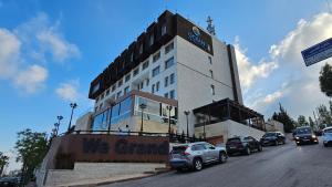 a building with cars parked in front of it at Ocean Grand Hotel - Ramallah in Ramallah