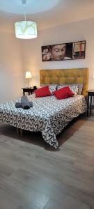a bedroom with a large bed with red pillows at Sweet Home in Valencia