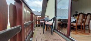 a balcony with a chair sitting on top of it at FeWo-Schmidt-im-Erzgebirge in Gelenau