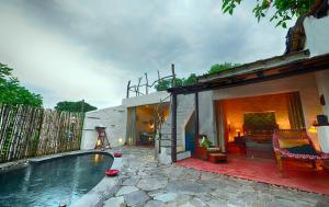 a house with a swimming pool in a yard at Paatlidun Safari Lodge, Jim Corbett in Garjia