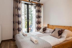 Posteľ alebo postele v izbe v ubytovaní udanypobyt Apartamenty Krzeptówki Potok