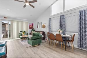 a living room with a green chair and a table at Endless Sunset- Near Beach Surf and Pet Friendly in Huntington Beach