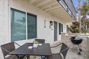 a patio with a table and chairs and a grill at Endless Sunset- Near Beach Surf and Pet Friendly in Huntington Beach