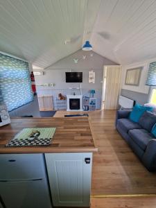 a kitchen and living room with a couch and a table at Chalet 88 in Aberystwyth