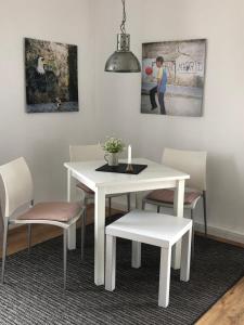 a white dining room table and chairs with a candle on it at Wohlfühloase Dresden Nickern in Dresden