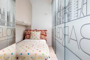 a bedroom with a bed and a wall with drawings on it at At-II Hub Luxury New Apartments in Barcelona