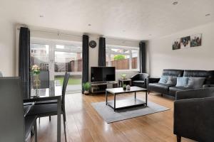 a living room with a couch and a table at Charming 3BR house with garden in Cambridge - Cherry Hinton in Cherry Hinton