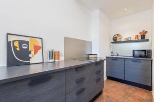 a kitchen with wooden cabinets and a counter top at HOMESTWENTY3 - Home ten in Caorle