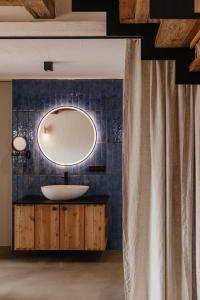 a bathroom with a sink and a mirror on the wall at FRANZL - privates Refugium AmWildbachberg, mit Infinitypool, Weinkeller und Privatsauna in Deutschlandsberg