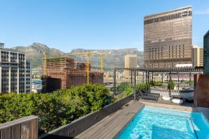 a swimming pool on top of a building with a city at The Duke Luxury Apartments in Cape Town