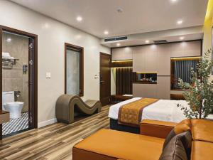 a hotel room with a bed and a bathroom at Napoli Hotel in An Khê