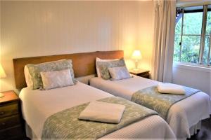 Llit o llits en una habitació de Bilyana Cottages