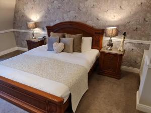 a bedroom with a bed with two night stands and two lamps at Abbey Hotel Donegal in Donegal