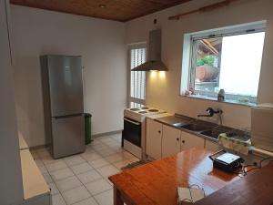 a kitchen with a stainless steel refrigerator and a sink at Alykesbeachhouse in Drosia