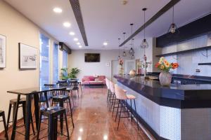 un restaurante con un bar con mesas y sillas en Ramblas Vendrell en El Vendrell