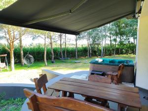 a patio with a table and chairs and a grill at u Niedzwiedzia in Niedźwiedź +9 photos