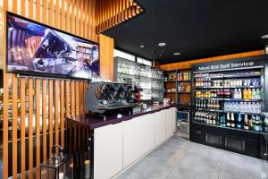 a restaurant with a bar with a tv in a room at Bo33 Hotel Family & Suites in Budapest