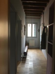 a room with a hallway with a window and a bench at Due Delfini Apartment in Venice