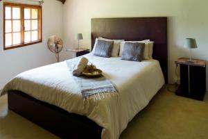 a bedroom with a large bed with a basket on it at Thaba Pitsi Safari Lodge in Bela-Bela