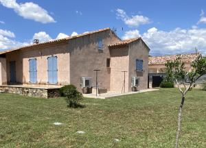a large house with a yard in front of it at Villa Triskyl in Le Muy