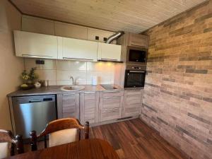 a kitchen with white cabinets and a sink in it at Vahtra allee külalismaja in Roodevälja