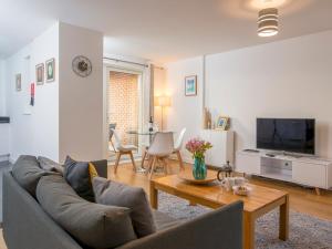 a living room with a couch and a table at Pass the Keys Lovely 2 Bedroom Apartment in the Bay with a view in Cardiff