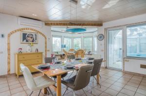 a dining room with a table and chairs at Holiday home Nika in Linardići