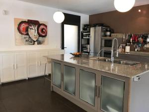a kitchen with a sink and a counter top at Villa con piscina privada in Olivella