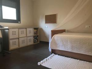 a bedroom with a bed and a window at Villa con piscina privada in Olivella +17 photos