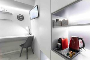a kitchen with a red appliance in a refrigerator at Lux seaside apartment by Volos hospitality in Volos