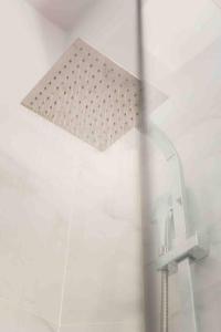 a white paper sticking out of a shower at Lux seaside apartment by Volos hospitality in Volos