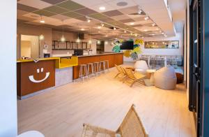 a lobby with a bar with chairs and a counter at Apparthotel Privilodges Toulon in Toulon