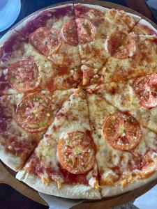 une pizza avec du piment et du fromage sur une table dans l'établissement Bella Louise Bar Resto, à Busuanga