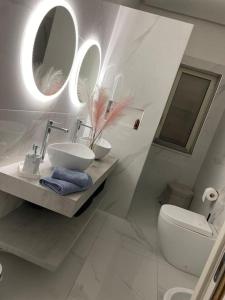 La salle de bains est pourvue d'un lavabo, de toilettes et de miroirs. dans l'établissement House Serapide Puteoli, à Quarto