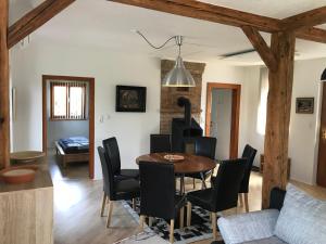 a dining room and living room with a table and chairs at Haus Fjord in Am See