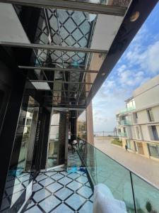 a balcony of a building with a view of the beach at Le palace suite by pestana hôtel in Casablanca