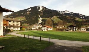 a village with a mountain in the background with a road at Bergblick in Westendorf