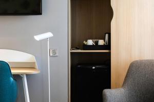 Телевизор и/или развлекательный центр в Holiday Inn Perpignan by IHG
