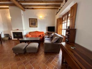 a living room with a couch and a table at Campanario 3 in Alájar