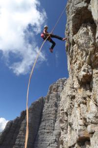 a person on a rope climbing on a mountain at Hotel Kreuzberg Monte Croce in Sesto