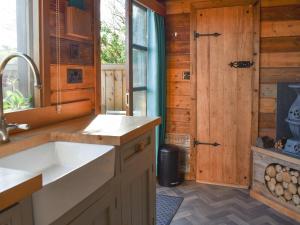 eine Küche mit einem Waschbecken und einer Holztür in der Unterkunft Milos View in Totnes