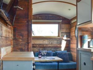 a kitchen with a table in a tiny house at Milos View in Totnes